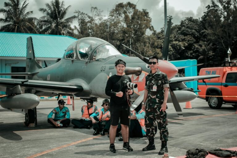 Personnel posing with a military aircraft on an airbase showcasing aviation activity and teamwork.